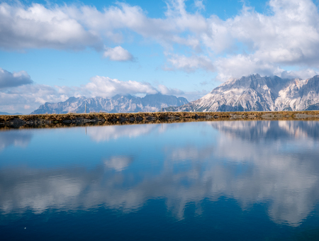 Image of mountain panorama with water reflections in lake in austriaの写真素材
