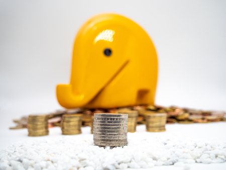 Image of pile of Euro coins with yellow piggy bank in the background close upの写真素材
