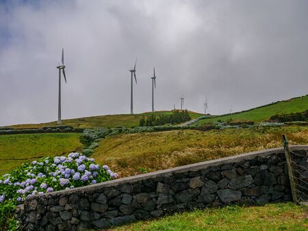 Image of a row of wind mills during unsettled weatherの写真素材