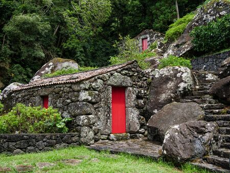 Image of old stone houses based on a hill landscape on the Azoresの写真素材