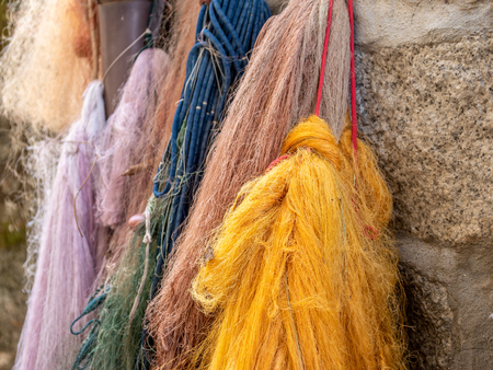 Image of colorful old and used fisher nets hanging on the wallの写真素材