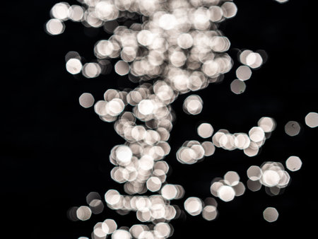 Dark background with white lense flairs. Bokeh balls. flat lay