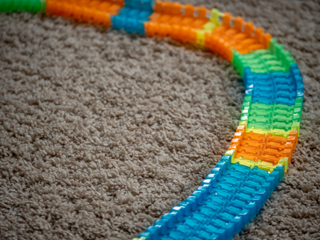 Image of toy car track with colorful track elements on carpet. close upの写真素材