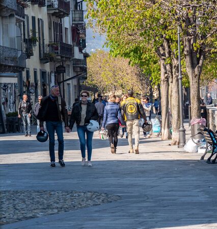 Ascona, Switzerland - April 15, 2019: People walking with biker leather fashion and biker helmets through the sunny cityのeditorial素材