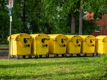 Image of Yellow waste Containers, Recycling bin for special Rubbish, during hail and rainy weatherの写真素材