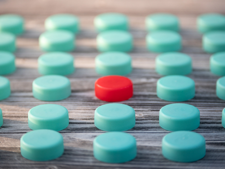 Image of different colored plastic caps on wooden background, creative conceptの写真素材