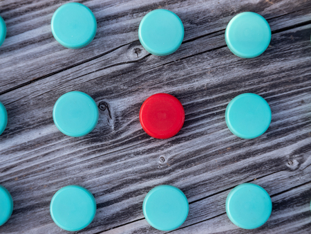 Image of different colored plastic caps on wooden background, creative conceptの写真素材