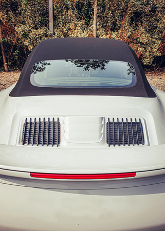 Image of rear view of white sportscar and red taillightの写真素材