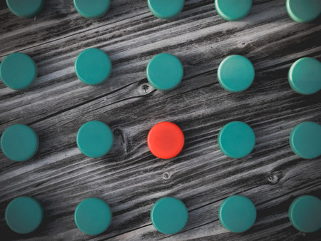 Image of different colored plastic caps on wooden background, creative concept