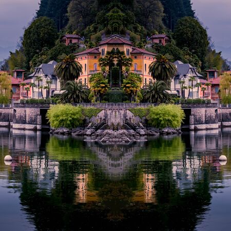 Image of cannero riviera at the lake maggiore with yellow sailing boat and buildings at the front of the lakeの写真素材