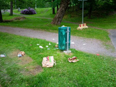 Helsinki, Finland- June 11, 2019: Waste next to trash bin in a park in Helsinkiのeditorial素材