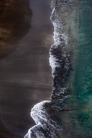 Top down view on waves at the shoreの写真素材