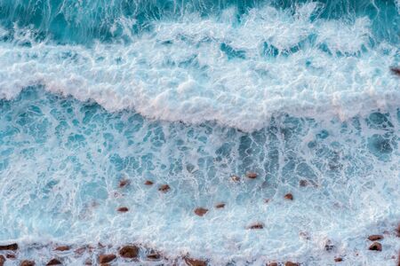 Top down view on waves at the shoreの写真素材