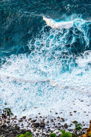 Top down view on waves at the shoreの写真素材