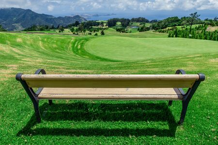 Park bench outdoor landscape. Wooden bench in golf course landscape. Mountain park bench panorama. Park bench relax, Madeiraの写真素材