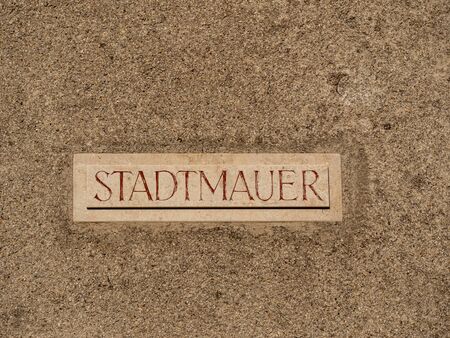 Old brown town wall with a sign Stadtmauer which means town wallの写真素材