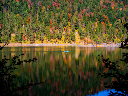 Autumn mountain forest lake house reflection in water landscape.Autumn lake reflection. Mountain...