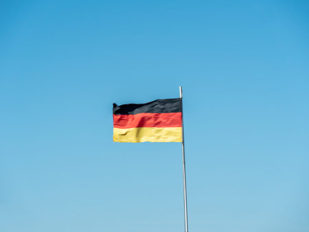 German flag. The German flag blowing in the wind on a clear blue day in spring