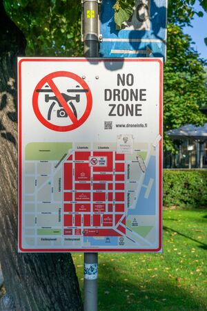 Helsinki, Finland - August 20, 2019: No drone zone Warning sign at fence wall, Prohibition sign to fly with drones on the net fence. No drone zone.のeditorial素材