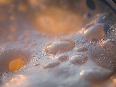 Close up image of delicious beer foam in sun ligth.の写真素材