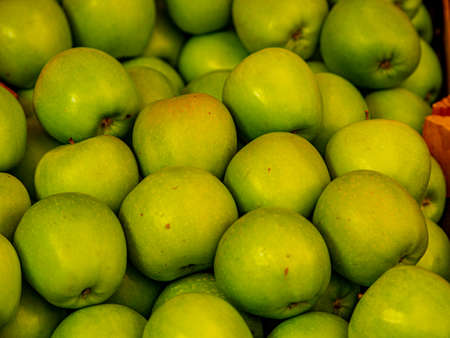 background of green apples on sale at the local marketの写真素材