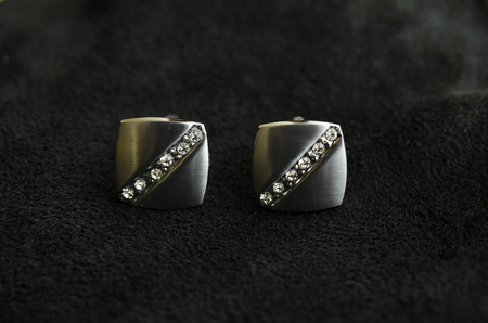 Silver cufflinks with rhinestone on the black matter at the centerの写真素材