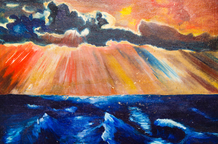 The horizontal image depicts the dark sea, the clouds and the sunset on the red skyの写真素材