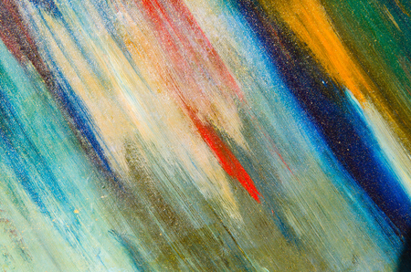 Glowing watercolor paint on the canvas, the canvas is a bit crumpled, red strokes, blue, green and white.の写真素材
