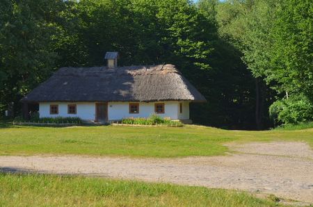 Large Ukrainian hut with a straw roof and wooden windowsの写真素材