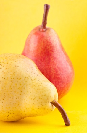 Yellow and red pears on yellow backgroundの写真素材