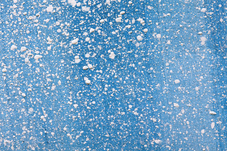 Abstract white paint splatter on blue background