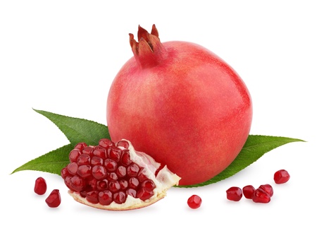 Ripe pomegranate fruit with leaves and seeds isolated on white backgroundの写真素材