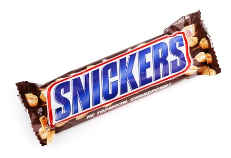 Closeup of Snickers candy chocolat bar made by Mars Inc. isolated on white backgroundのeditorial素材