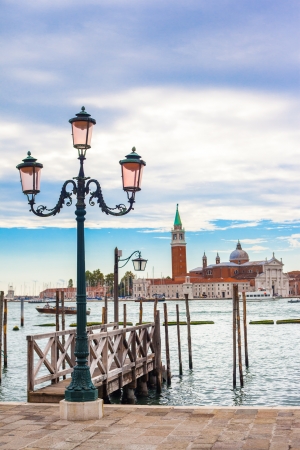 Old street lantern in Venice with the isle of San Giorgio Maggiore in the backgroundの写真素材