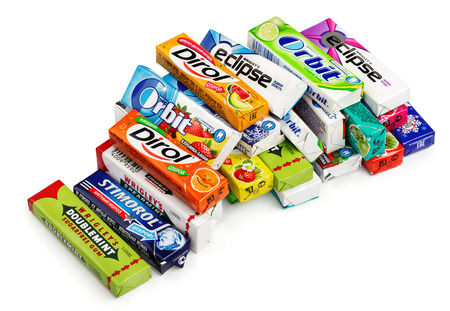 Heap of various brand chewing or bubble gum including Orbit, Dirol, Eclipse, Stimorol, Wrigley Spearmint and Doublemint isolated on white with clipping pathのeditorial素材