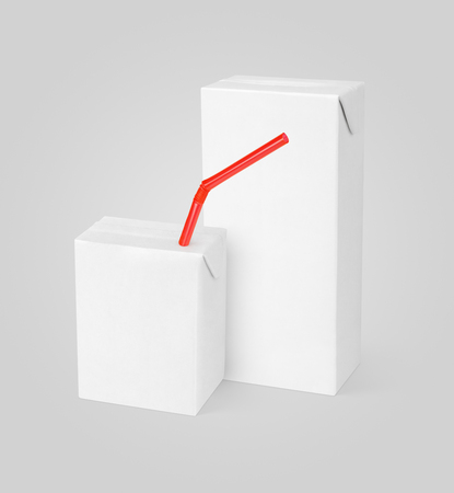 Group of different milk or juice carton packages with red straw on gray background with clipping pathの写真素材