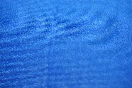 Creased blue cloth material fragment as a background textureの写真素材