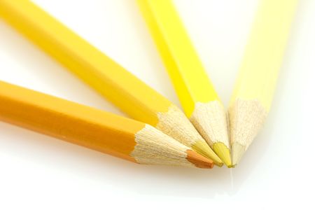 Variously tinted yellow pencils on a white backgroundの写真素材