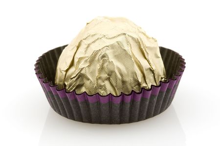 Sweet choco candy wrapped in golden foil, white background の写真素材