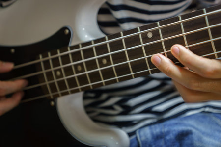 bass guitar finger style closeup - musical instruments - concept musical composition and creativity
