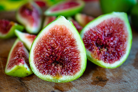 Fig - fresh figs and sliced fig fruits close-up showing texture on cutting board
