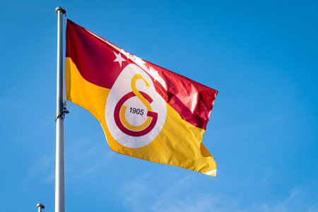 Istanbul, Turkey - November 2021: Galatasaray S.K. flag waving with the blue sky background....