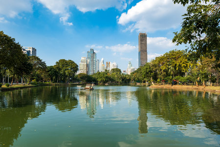Lumpini park in Bangkok and the skyline of downtown Bangkok central area. Lumphini park is a popular...