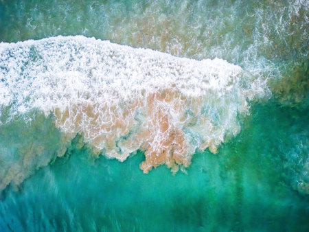 sea waves breaking and crashing surface by drone, abstract water wave shapes