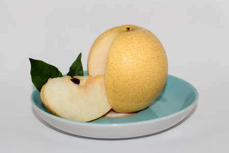 Fresh pears on a plate, on a white backgroundの写真素材