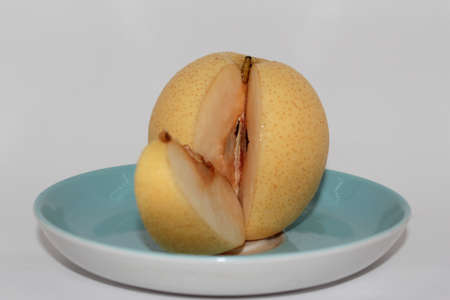 Fresh pears on a plate, on a white backgroundの写真素材