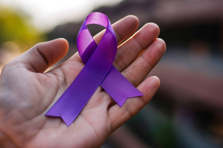 A Hand Holding a Purple Ribbon in Support of Cancer Awareness. cancer dayの素材
