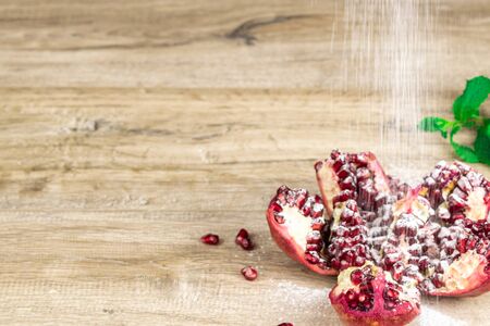 Pomegranate with mint on a wooden backgroundの写真素材
