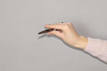 Woman holding hairdressers scissors on white backgroundの写真素材