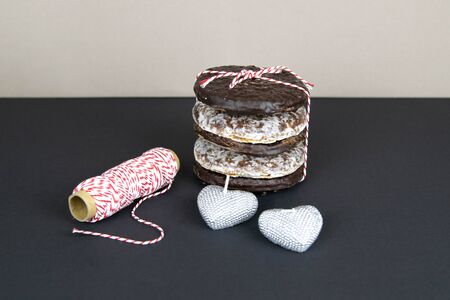 Background until Valentines Day with hearts, angel and chocolate ginger biscuits wrapped in white-red threadの写真素材